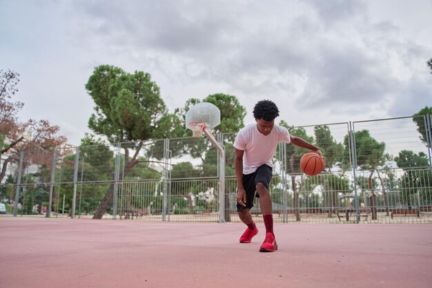 Basketball player training on a court in the city