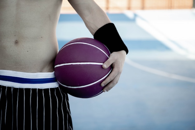 Basketball player with a ball ready to play