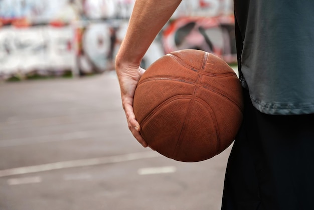 Basketball player with a basketball ball on an outdoor sports ground Sports concepts