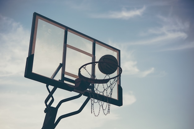 Basketball with sky at sunset