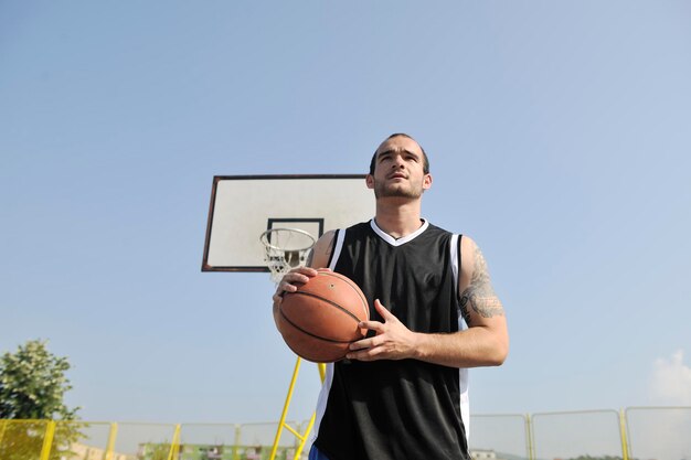 basketbalspeler die oefent en poseert voor basketbal en sportatleetconcept