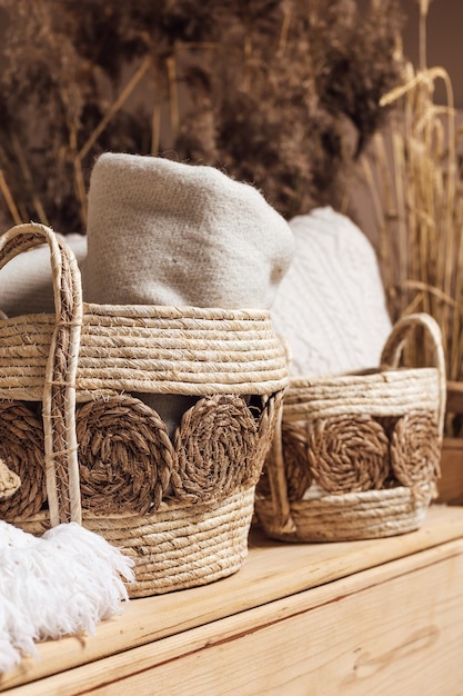 Baskets with plaid made of natural materials and other homemade decorations for home interior