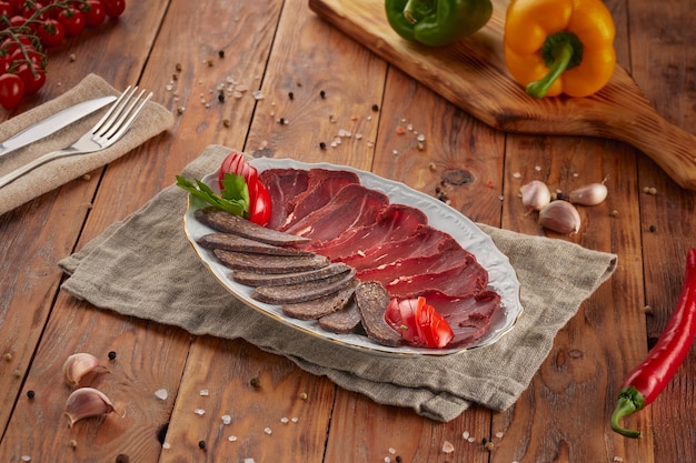 Basturma meat cuts, wooden background