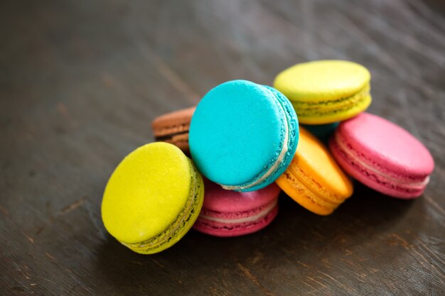 A batch of coloroful French macaroons on a brown table