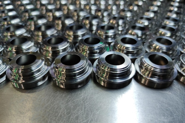 A batch of shiny metal cnc aerospace parts production closeup with selective focus for industrial background
