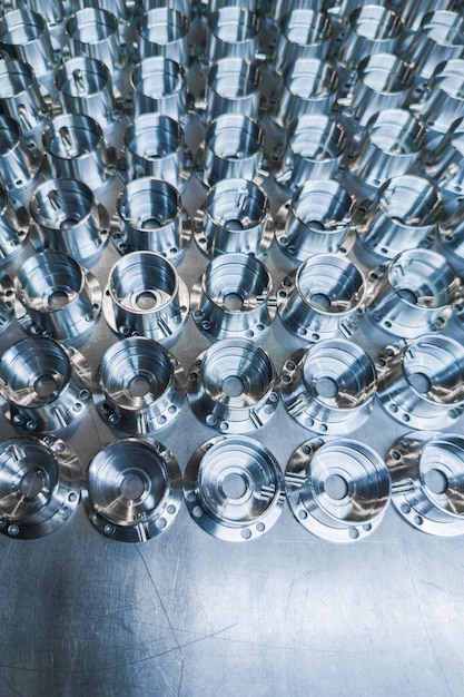 A batch of shiny metal cnc aerospace parts production closeup with selective focus for industrial background