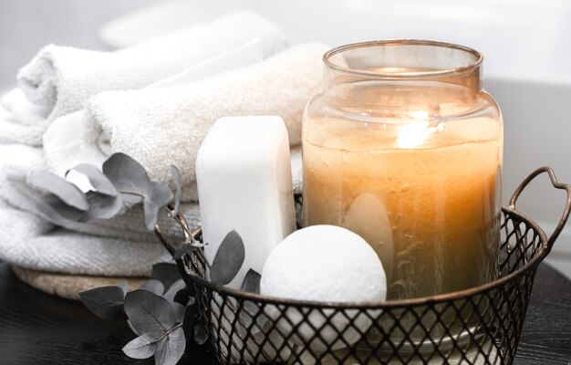 Bath accessories and a burning candle. Body care and hygiene concept.