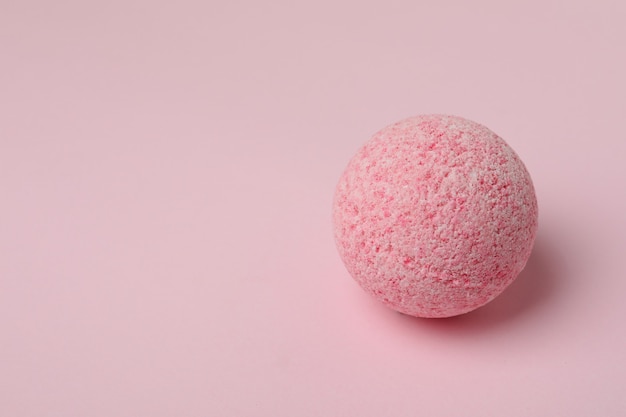 Bath ball on pink background, space for text