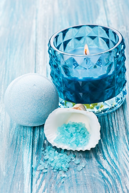 Bath bomb closeup with blue lit candle