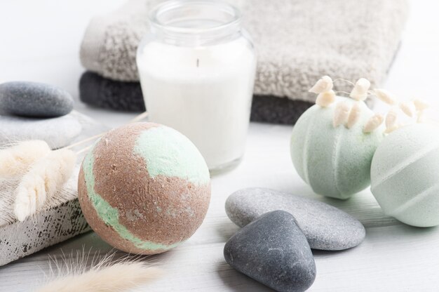 Bath bombs with lit candles and towels