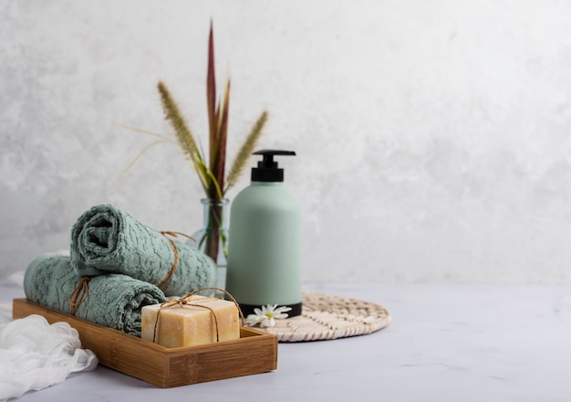 bath concept with soap bottle and towels