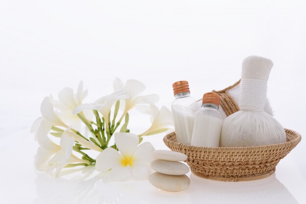 Bath products and skincare treatment with Plumeria spa flower on white 