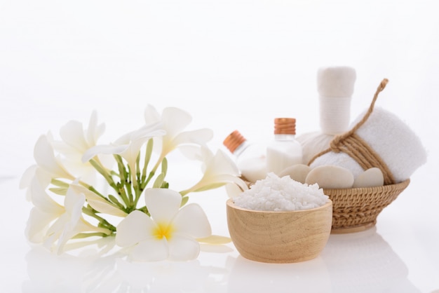 Bath products and skincare treatment with Plumeria spa flower on white 