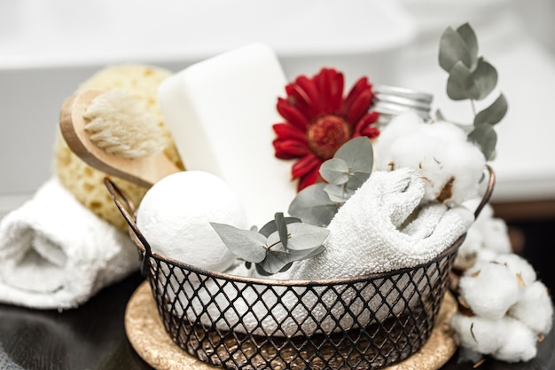 Bath towel and bath bomb and red flower. Hygiene and health concept.