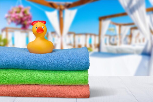 Bath towels and Yellow rubber duck on table