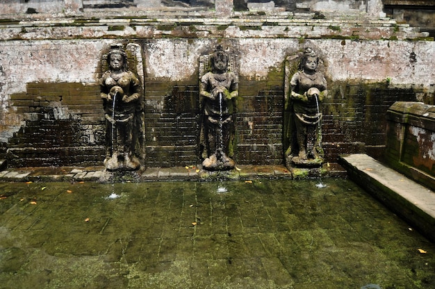 Bathing temple figures or holy water fountain of Goa Gajah or Elephant Cave significant Hindu archaeological site for travelers people travel visit and respect at Ubud city town in Bali Indonesia