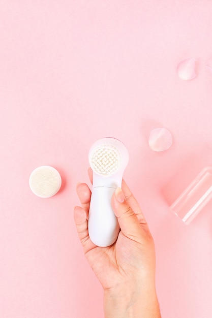 Bathroom accessories on a pastel pink background