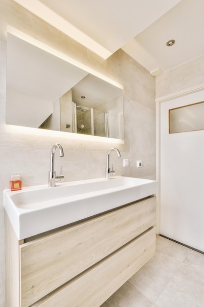 Bathroom in gray tones with a double ceramic sink in a modern house