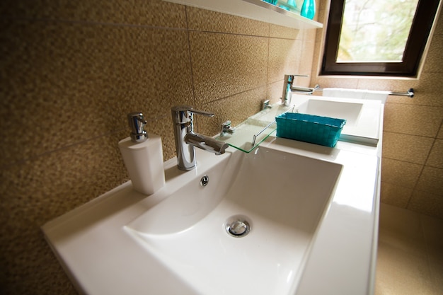 Photo bathroom interior  washbasin bidet toilet large mirror the walls are light brown in color