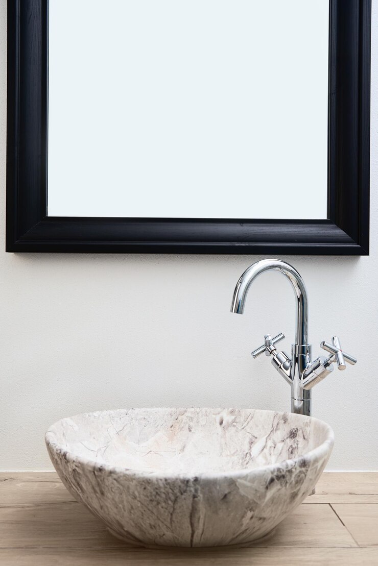 Photo bathroom interior with marble sink and faucet