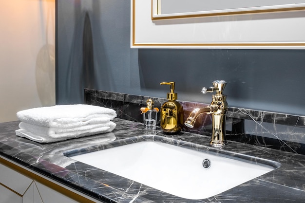 Bathroom interior with sink and golden faucet