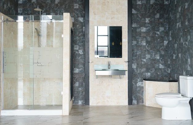 bathroom interior with white walls, a shower cabin with glass wall and faucet sink