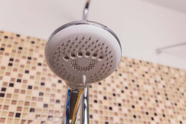 In the bathroom open shower mixer has attached to the wall bracket tinted black and white image