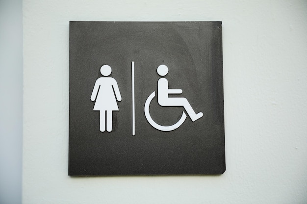 A bathroom sign with a woman and a man on it