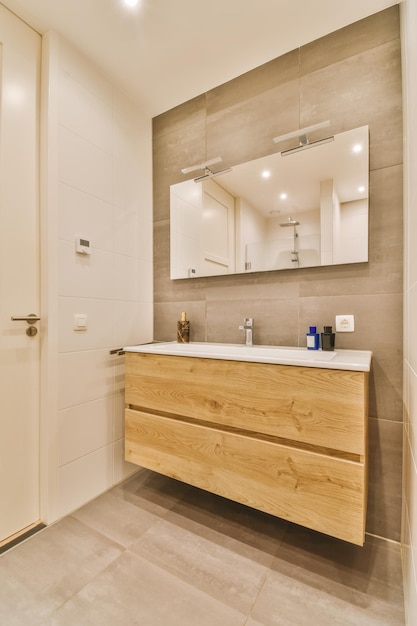 A bathroom with a large mirror and a wooden vanity