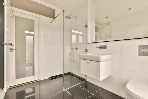 A bathroom with a sink and shower and a mirror