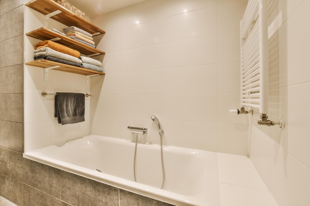 A bathroom with a tub and a shower and shelves