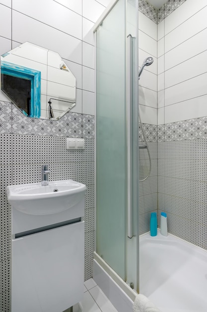 Bathroom with white tiles mirror and washbasin