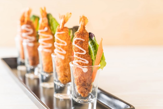  batter-fried prawns on wood