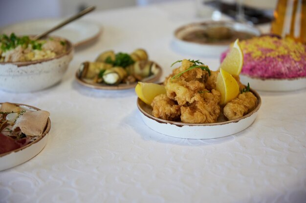 battered fish and lemon on a set table in a restaurant