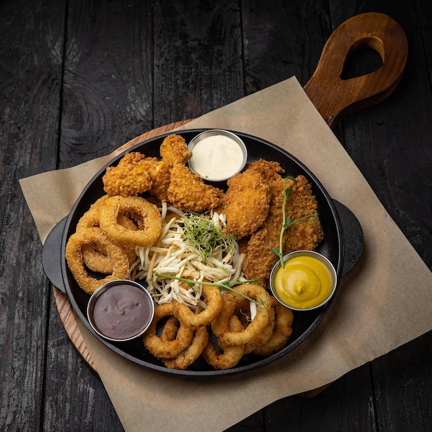 battered seafood in a pan on a black background