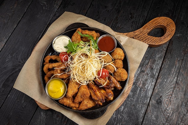 battered seafood in a pan on a black background