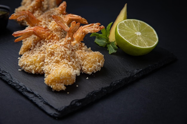 battered shrimp on a dark background