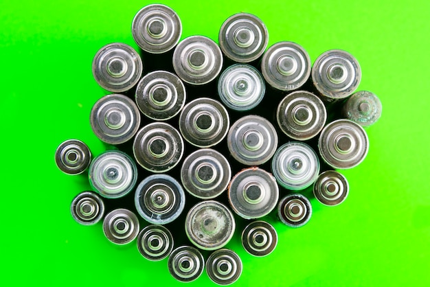 Batteries on a green background. battery recycling, environmental.