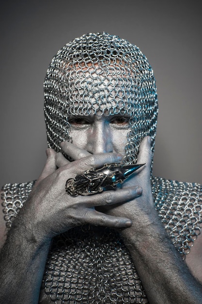 Battle, man in chain mail and leather painted silver, medieval warrior