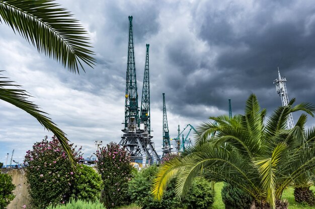 BATUMI GEORGIA SEPTEMBER 2021 sea port with cargo cranes and loading barges on Black Sea with overcast sky