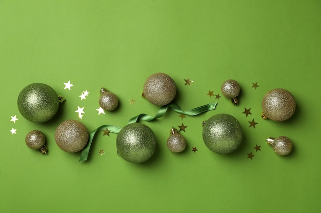 Baubles, stars and ribbon on green background