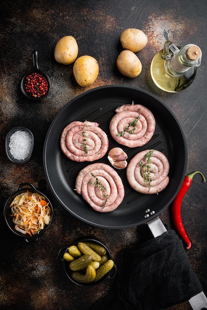 Bavarian fried sausages on sauerkraut in cast iron frying pan