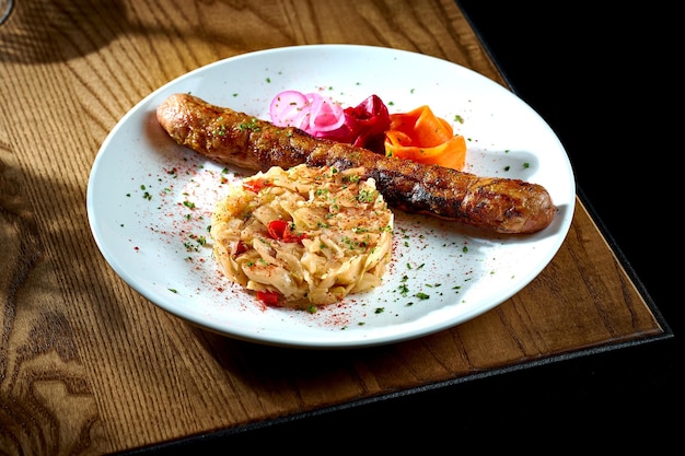 Bavarian meat sausage with a garnish of stewed sauerkraut onions in a plate on a wooden background