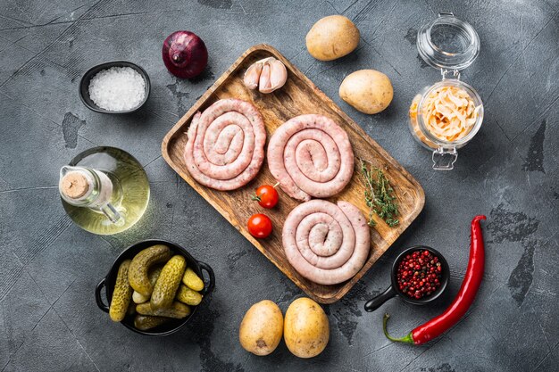 Bavarian sausage mashed potatoes and sour cabbage, on gray background, top view flat lay