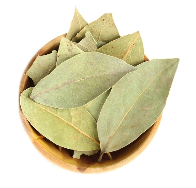 Bay leaves in wooden bowl isolated on white