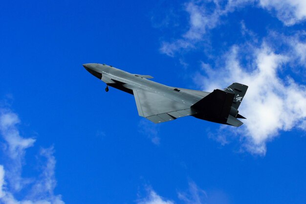 Bayraktar Kzlelma unmanned fighter jet gliding through the white clouds.