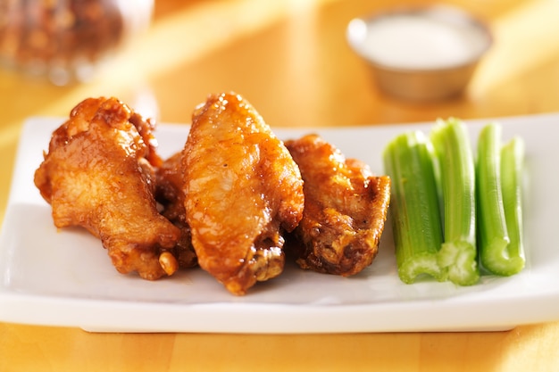 Bbq buffalo chicken wings with ranch dip and celery