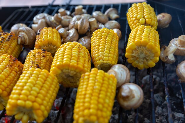 BBQ Champignon mushrooms and corn grilled on grill