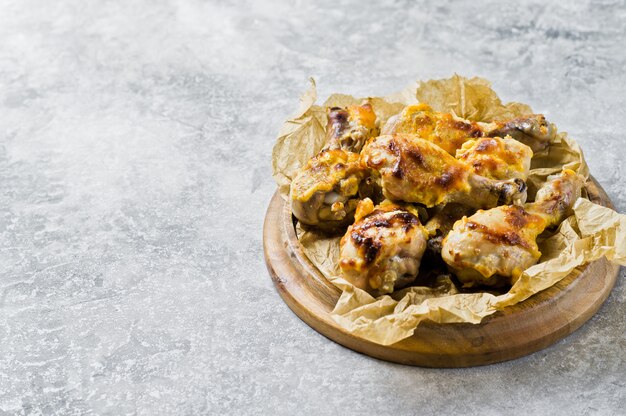 BBQ chicken legs on the tray with the Kraft paper. 