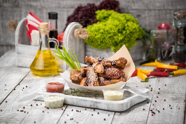 BBQ Chicken wings in a white bucket